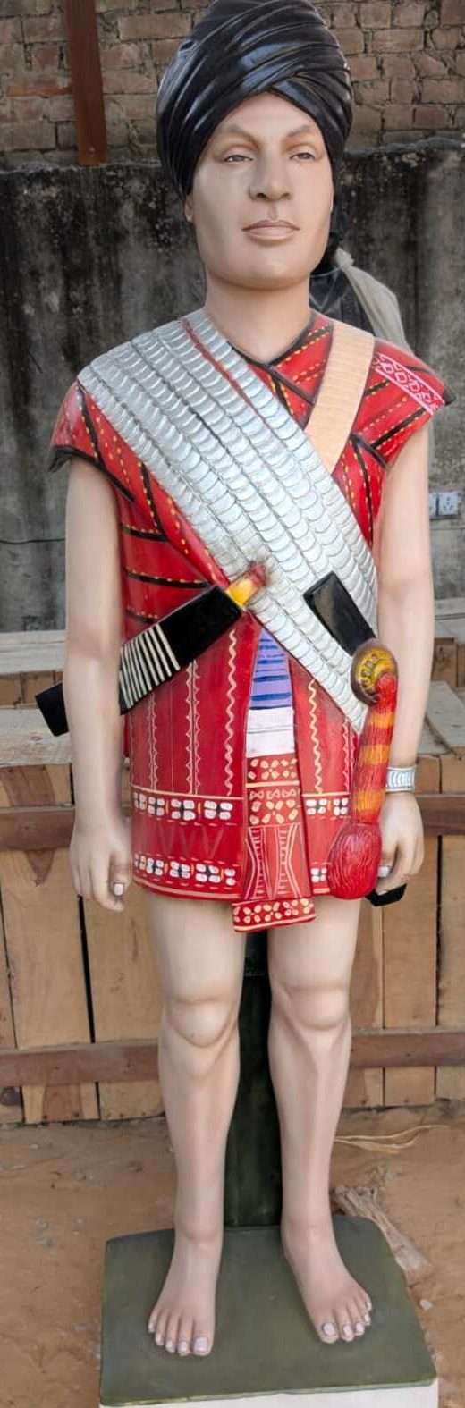 Painted statue of tribal man in red traditional dress
