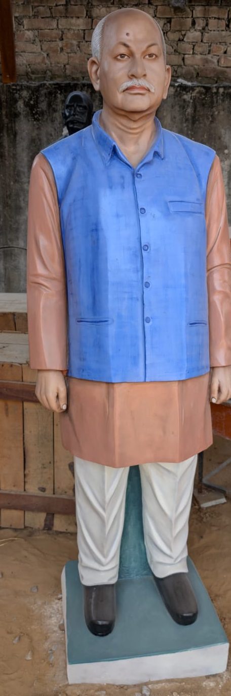 Painted statue of gentleman in blue jacket and kurta