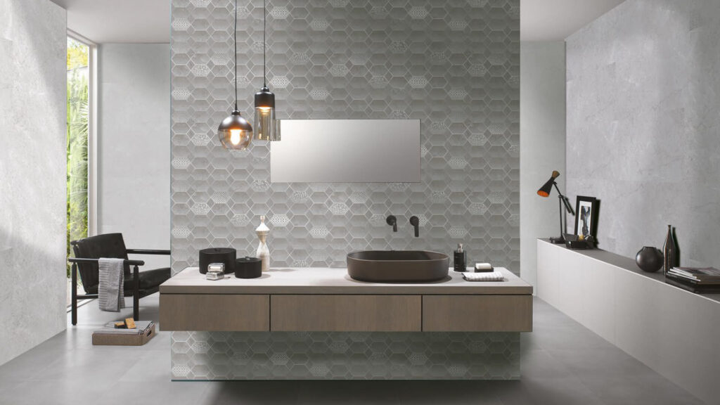 Designer bathroom with quartz vanity and textured stone feature wall.