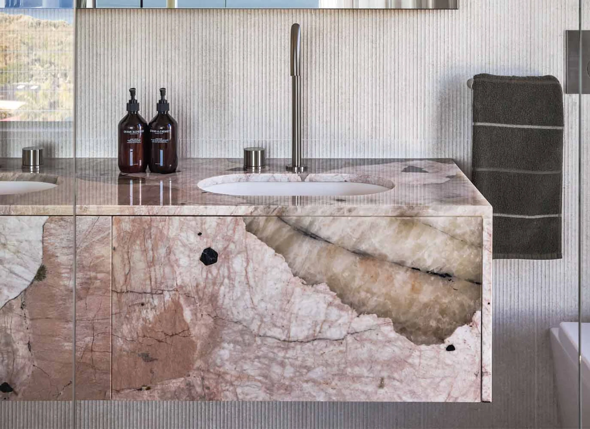 Pink Patagonia Quartzite bathroom vanity with polished stone surface.